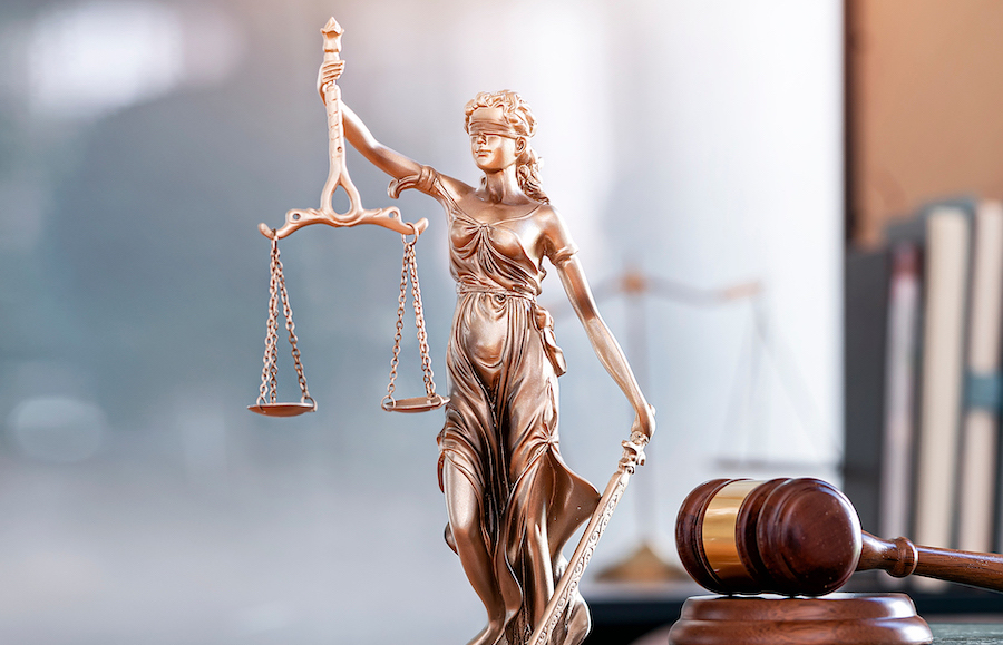Legal and law concept. Statue of Lady Justice with scales of justice and wooden judge gavel on wooden table. Panoramic image statue of lady justice.